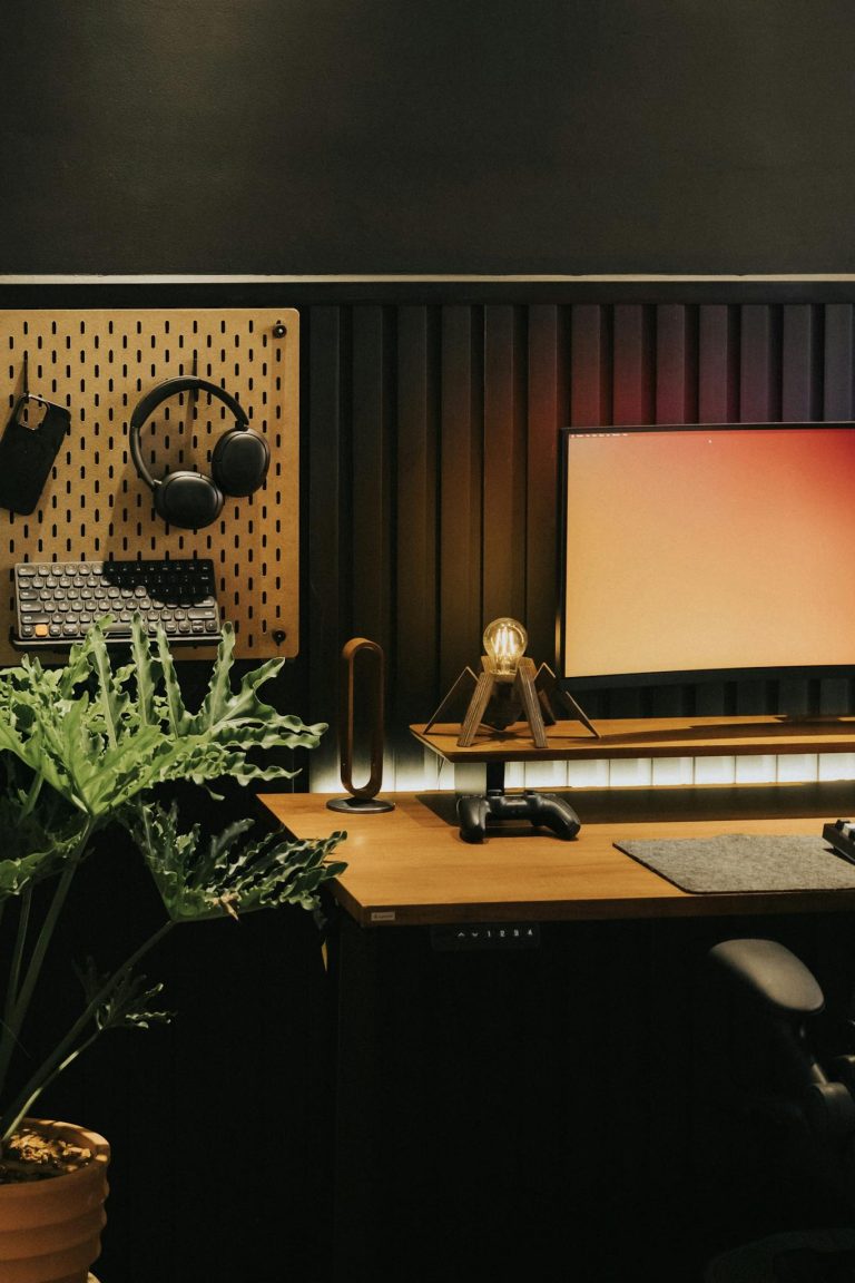 Stylish desk setup featuring gaming gear and greenery for productivity.